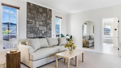 a living room with a couch and a table at Temecula Stay w Pool Movie Room Sauna Tennis Court Panoramic Valley Views Via de Oro Estate by Avantstay in Temecula