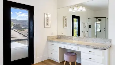a bathroom with a large sink and a mirror at Temecula Stay w Pool Movie Room Sauna Tennis Court Panoramic Valley Views Via de Oro Estate by Avantstay in Temecula