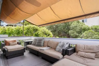 a patio with a couch and two chairs and a table at Darling Del Mar Beach Cottage with Ocean Views in San Diego