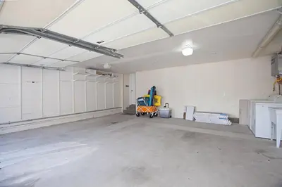an empty garage with a cart in the middle of it at Relaxing Beach Bungalow in San Diego