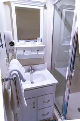 a white bathroom with a sink and a shower at Mission Bay Studio w Ocean Views from Rooftop Deck in San Diego