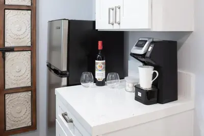a bottle of wine sitting on a counter with wine glasses at Charming Private Mission Bay Studio 2 in San Diego
