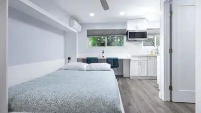 a white bedroom with a bed and a kitchen at Charming Private Mission Bay Studio 2 in San Diego