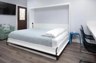 a bedroom with a white bed and a table and chairs at Charming Private Mission Bay Studio 2 in San Diego