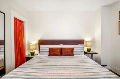 a bedroom with a large bed with two pillows at Bright and Quirky Hillcrest Craftsman in San Diego