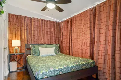 a bedroom with a red brick wall with a bed at Bright and Quirky Hillcrest Craftsman in San Diego