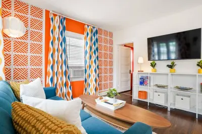 a living room with a blue couch and a table at Bright and Quirky Hillcrest Craftsman in San Diego