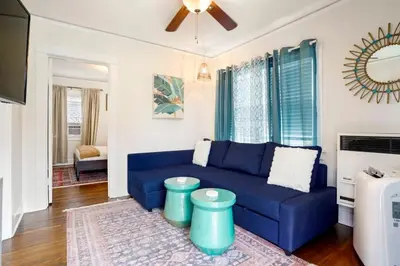 a blue couch in a living room with a ceiling fan at Adorable Quirky Hideaway BIG Private Enclosed Yard in San Diego