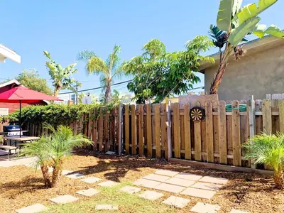 a wooden fence in front of a house at Adorable Quirky Hideaway BIG Private Enclosed Yard in San Diego