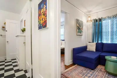 a living room with a blue couch and a window at Adorable Quirky Hideaway BIG Private Enclosed Yard in San Diego