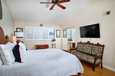 a bedroom with a bed and a flat screen tv at 152-4 Coastal Luxury with Panoramic Ocean View in Oceanside