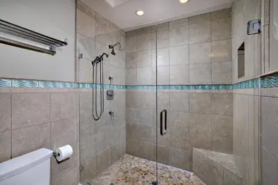 a bathroom with a shower with a glass door at 152-4 Coastal Luxury with Panoramic Ocean View in Oceanside