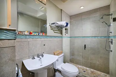 a bathroom with a toilet and a sink and a shower at 152-4 Coastal Luxury with Panoramic Ocean View in Oceanside