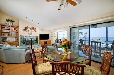 a living room with a table with flowers on it at 152-4 Coastal Luxury with Panoramic Ocean View in Oceanside