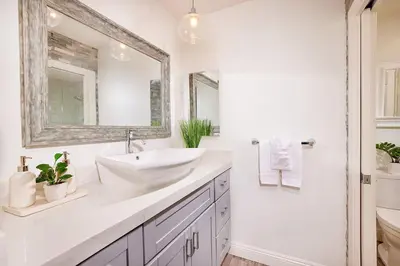 a white bathroom with a sink and a mirror at 152-6 S Pacific Fantastic Ocean View in Oceanside