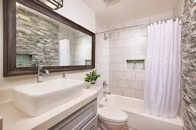 a bathroom with a sink and a toilet and a mirror at 152-6 S Pacific Fantastic Ocean View in Oceanside