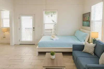 a living room with a bed and a couch at Urban Nest with private Patio in Golden Hill - walk everywhere! in San Diego