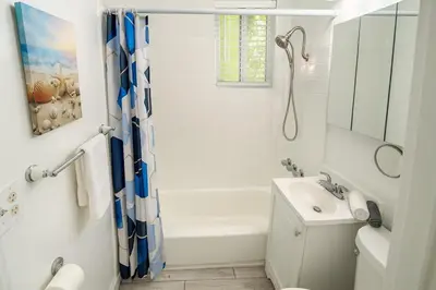 a bathroom with a white tub and a sink and a shower at Urban Nest with private Patio in Golden Hill - walk everywhere! in San Diego