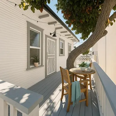 a table and chairs on a porch with a tree at Urban Nest with private Patio in Golden Hill - walk everywhere! in San Diego