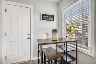 a dining room with a table and chairs and a window at 1BD Remodeled Craftsman Cottage Free parking Heart of lIttle Italy in San Diego