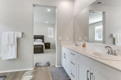 a bathroom with two sinks and a large mirror at Near Hospitals Home with Pool Access in Temecula in Temecula
