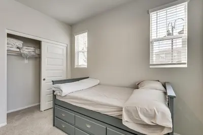 a bedroom with a bed and two windows at Near Hospitals Home with Pool Access in Temecula in Temecula