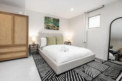 a bedroom with a large white bed and a window at Brand New Studio in Carlsbad in Carlsbad