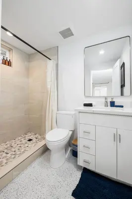 a bathroom with a toilet and a sink and a shower at Brand New Studio in Carlsbad in Carlsbad