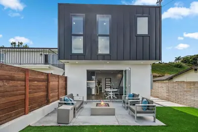 a house with a black roof with a fire pit at Designer Canyon House in La Jolla in San Diego