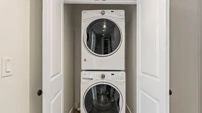 two washing machines are in a white room at Steps to the Beach Hot Tub Fire Pit 257 Trailhead Trestles 2 by AvantStay in San Clemente