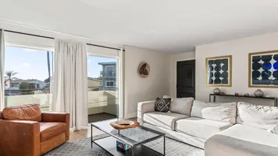 a living room with a couch and a chair at Steps to the Beach Modern 3BDR w Patio 257 Trailhead Trestles 1 by AvantStay in San Clemente