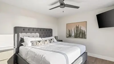 a bedroom with a bed with a ceiling fan at Steps to the Beach Modern 3BDR w Patio 257 Trailhead Trestles 1 by AvantStay in San Clemente