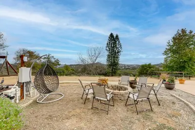 a group of chairs sitting around a fire pit at Near Hiking Trails! Luxe Family Home in Lakeside in Lakeside