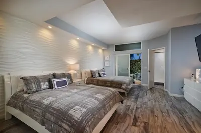 a bedroom with two beds and a tv in it at Stunning 4 BR 3 BA Convention Center Gaslamp Petco in San Diego