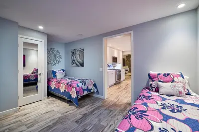 a bedroom with a bed and a mirror at Stunning 4 BR 3 BA Convention Center Gaslamp Petco in San Diego