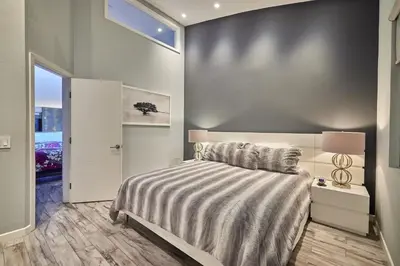 a bedroom with a large bed and a window at Stunning 4 BR 3 BA Convention Center Gaslamp Petco in San Diego