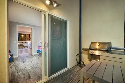 a kitchen with a sliding glass door and a grill at Stunning 4 BR 3 BA Convention Center Gaslamp Petco in San Diego
