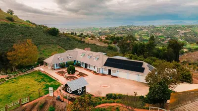 an aerial view of a large house with a driveway at 6BR Enchanted Estate on 5 Acres Pool & Mini Horses in Bonsall
