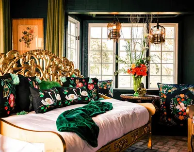 a bedroom with a bed with a green blanket on it at 6BR Enchanted Estate on 5 Acres Pool & Mini Horses in Bonsall