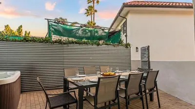 a black table and chairs on a patio at 2 Condos Steps to the Beach Hot Tub Trestles Trailhead Duo by AvantStay in San Clemente