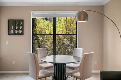 a dining room with a table and chairs and a window at Modern 2BR Cozy Apartment in Irvine in Lake Forest