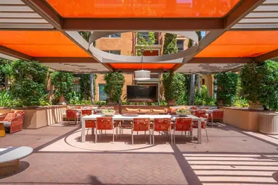 an outdoor patio with tables and chairs and a tv at Modern 2BR Cozy Apartment in Irvine in Lake Forest