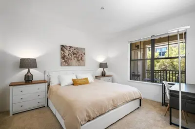 a bedroom with a bed and a desk and a window at Modern 2BR Cozy Apartment in Irvine in Lake Forest
