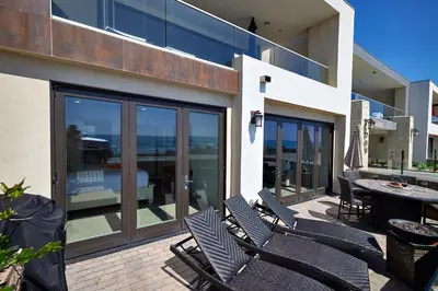 a patio with chairs and a table on a balcony at 700-104 Water Front Condo w AC in Oceanside