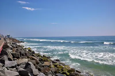 a group of people standing on a rocky beach at 700-104 Water Front Condo w AC in Oceanside
