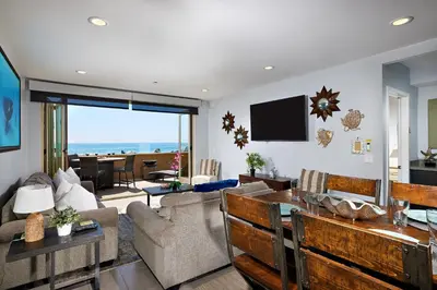 a living room with a couch and a table at 700-104 Water Front Condo w AC in Oceanside