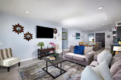 a living room with a couch and a tv on the wall at 700-104 Water Front Condo w AC in Oceanside