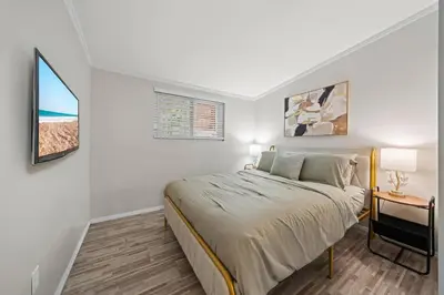 a small bedroom with a bed and a window at Entire Private Home with 4 Bedrooms 2 Bathrooms, 6 Beds, Hot Tub, King Bed, 6 Parking, Big Yard, Available Now in Spring Valley