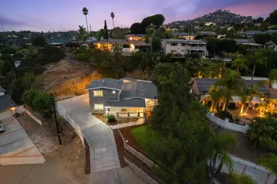 an aerial view of a home at dusk at Entire Private Home with 4 Bedrooms 2 Bathrooms, 6 Beds, Hot Tub, King Bed, 6 Parking, Big Yard, Available Now in Spring Valley