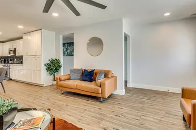 a living room with a couch and a table at 4 Mi to Dtwn Oceanside and Beach Home with Yard! in Oceanside